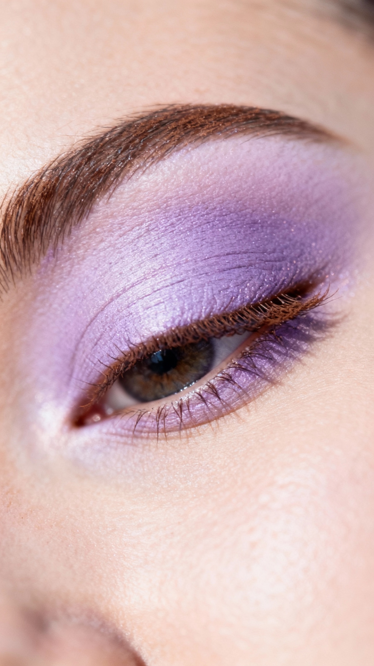 Closeup pastel lavender eyelid with smudged brown lashline