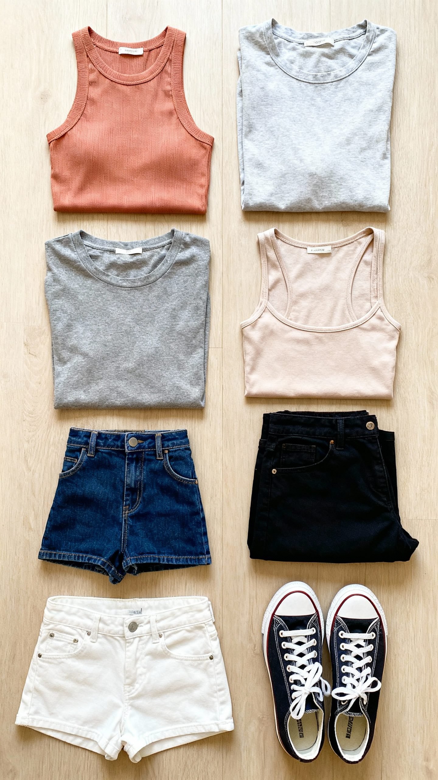 flat lay: 7 tops, 5 bottoms, two sneakers, daylight